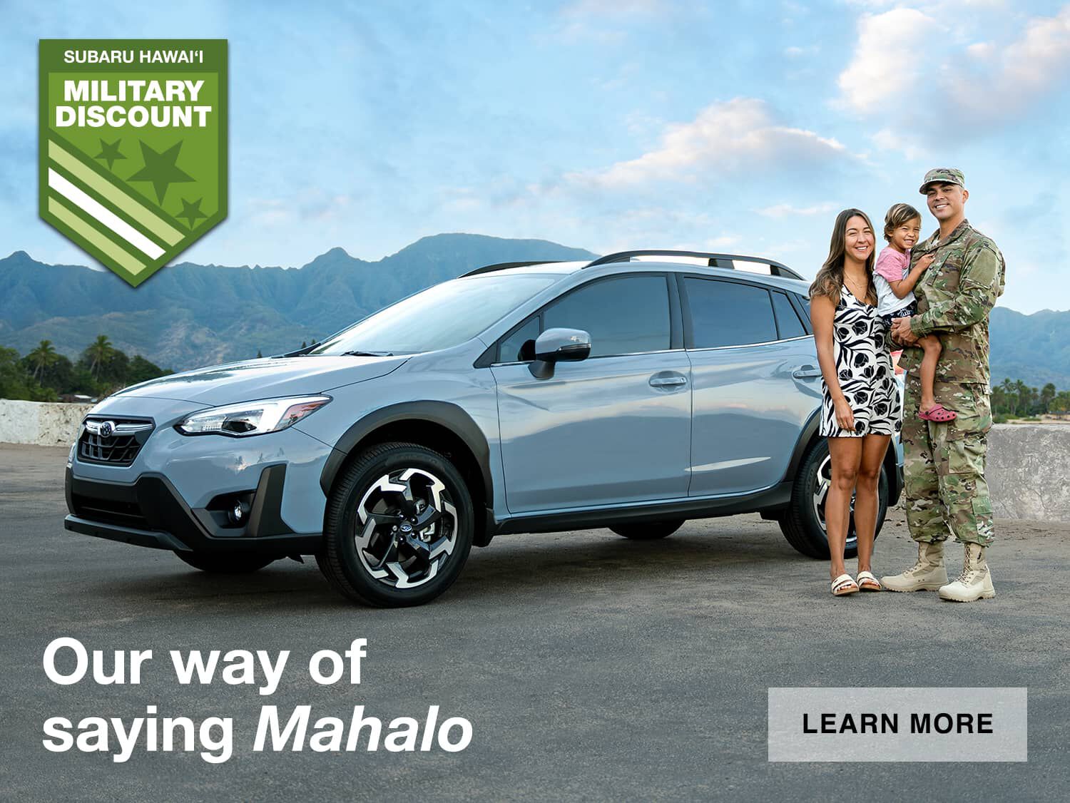 Family posing alongside a Subaru Crosstrek.