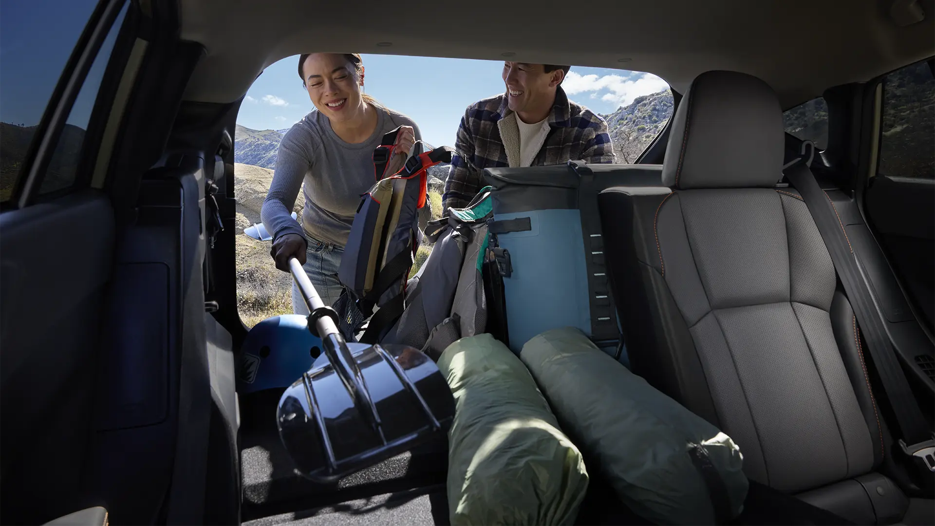 People loading gear in trunk of Crosstrek Hybrid.