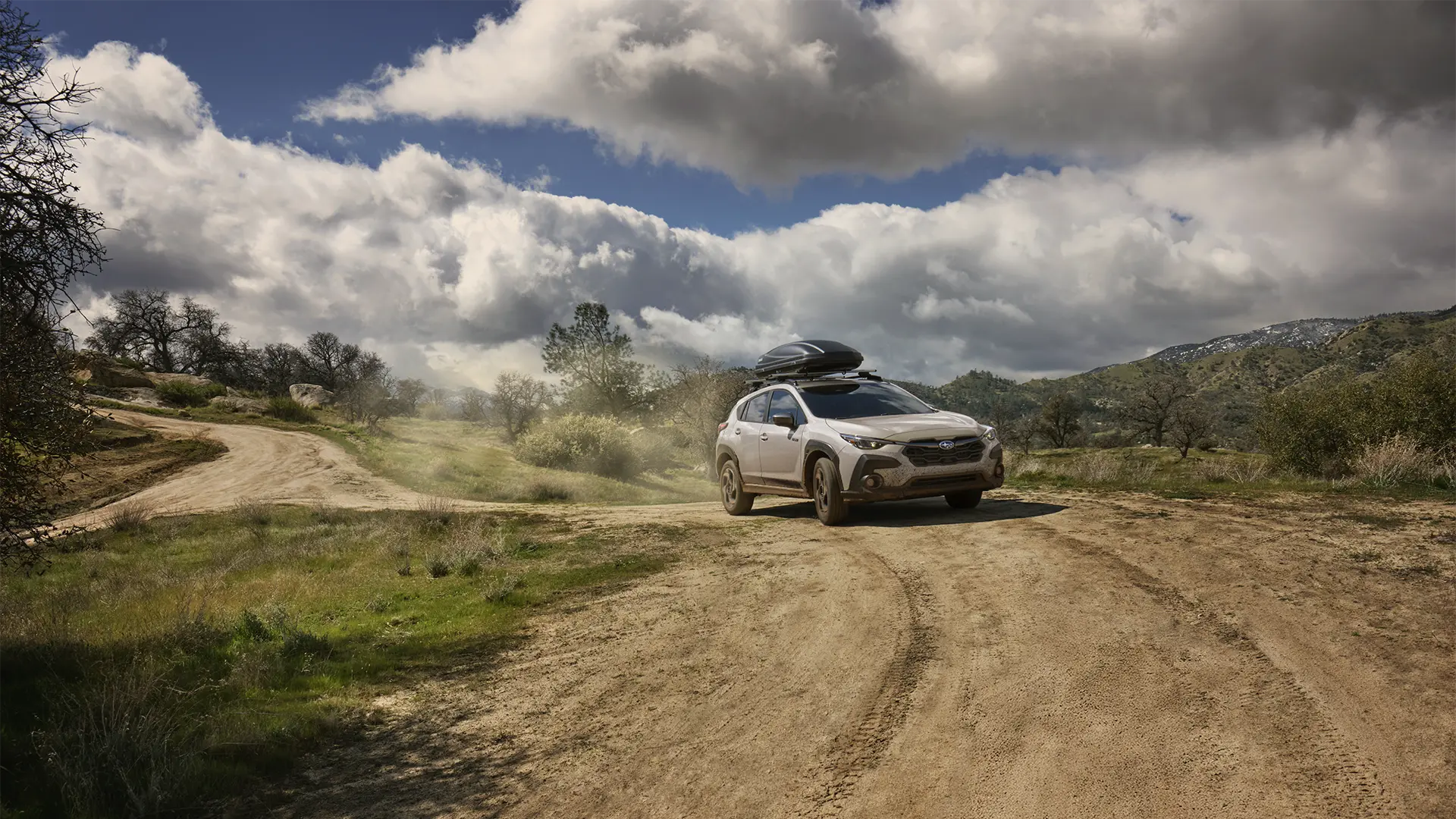 Crosstrek Hybrid driving on dirt path.