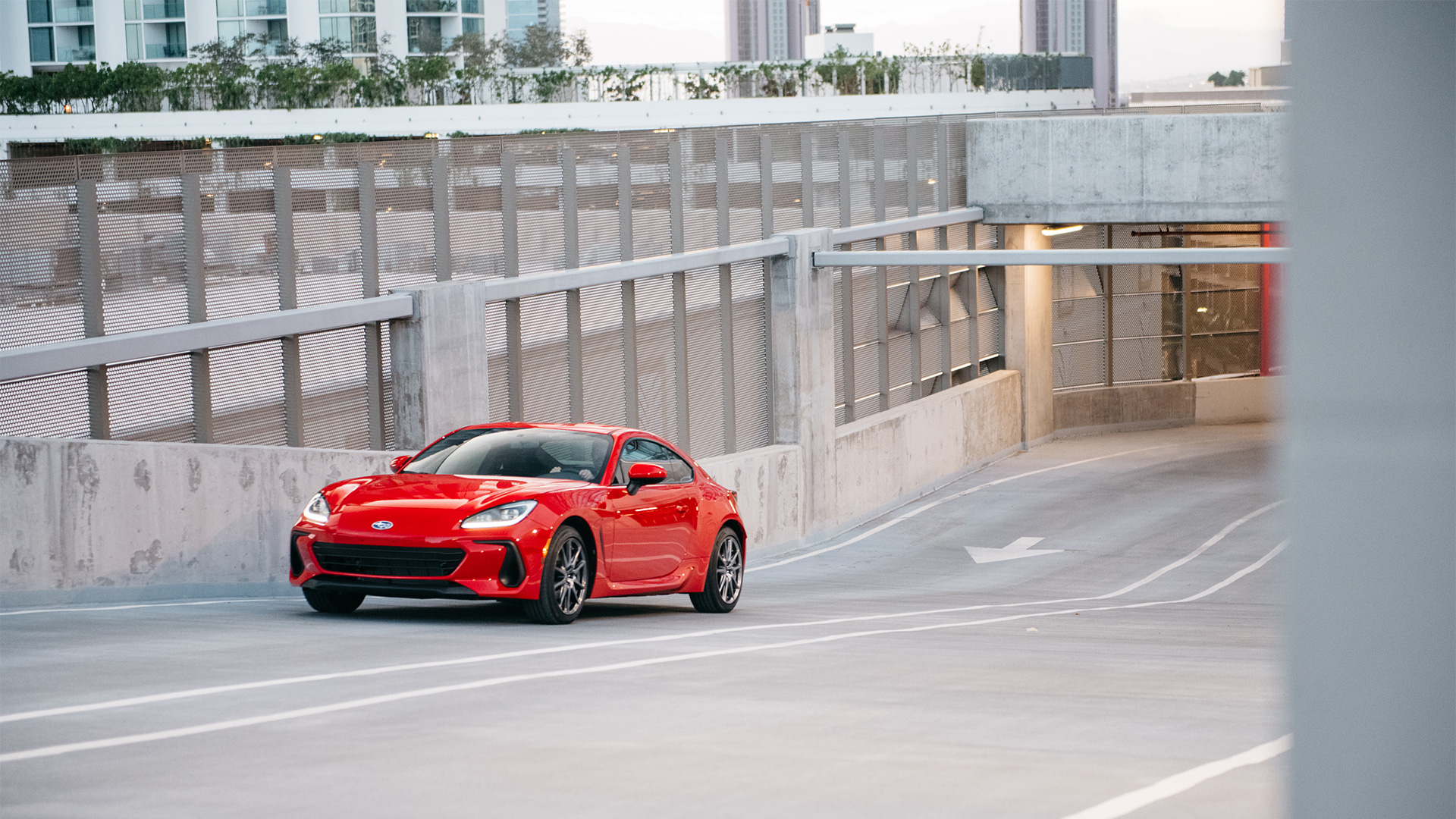 BRZ Premium shown in Ignition Red driving up ramp.
